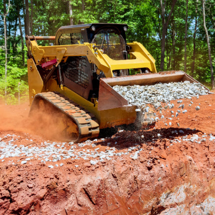 Skid LoadersExcavator carrying stone to a trench